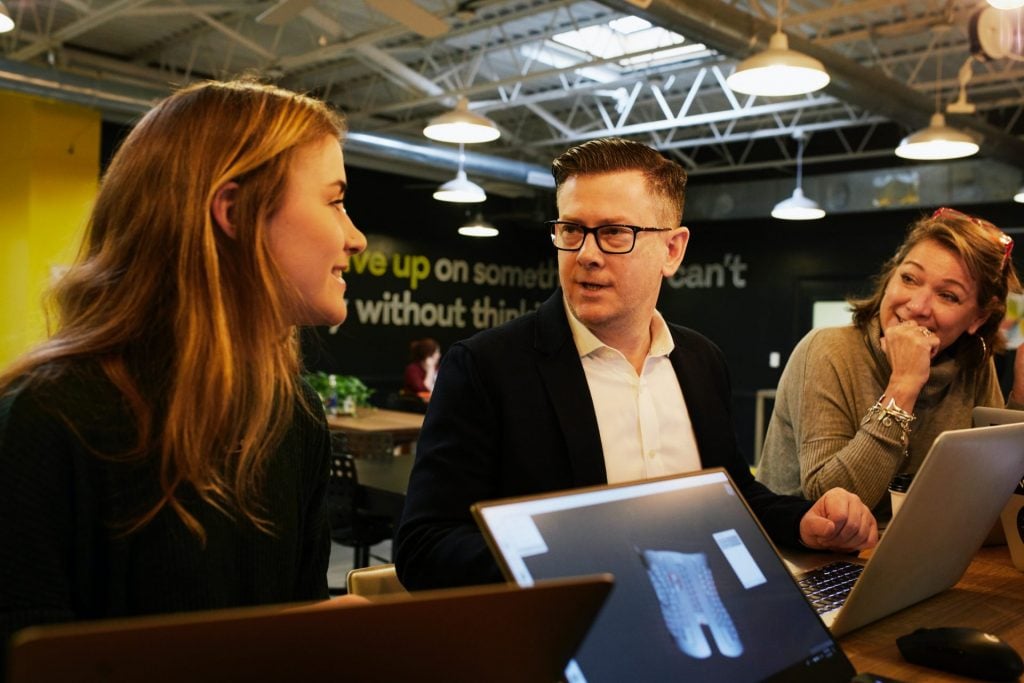 man and two women sitting beside table - STEP 3 Talk About Sales Prices After Establishing Value