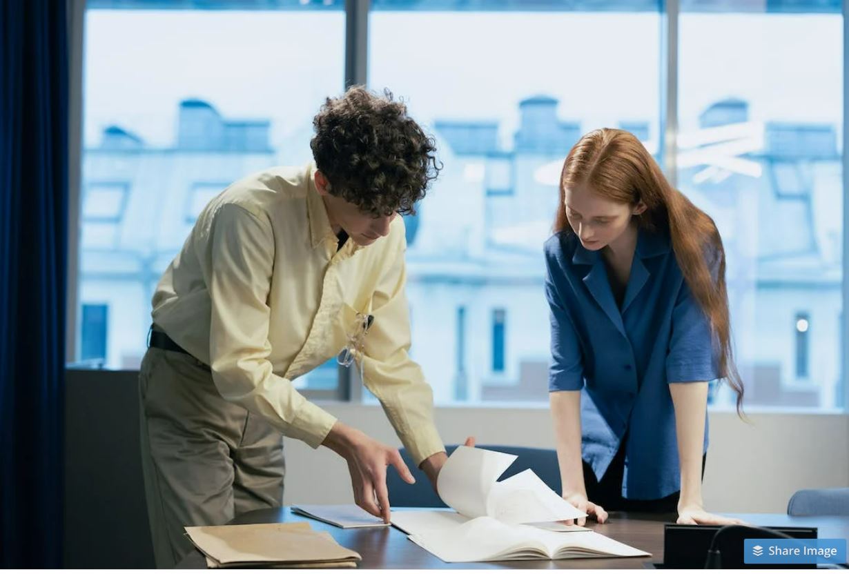 Photo of office workers discussing the papers on the table