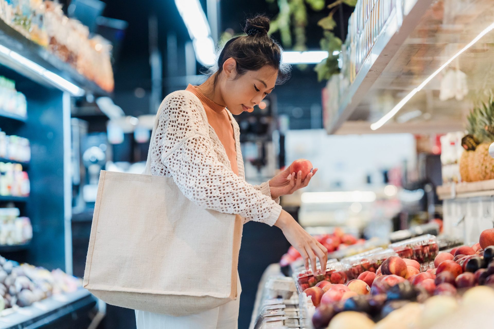 Image of a lady shopping vegetables in the grocery