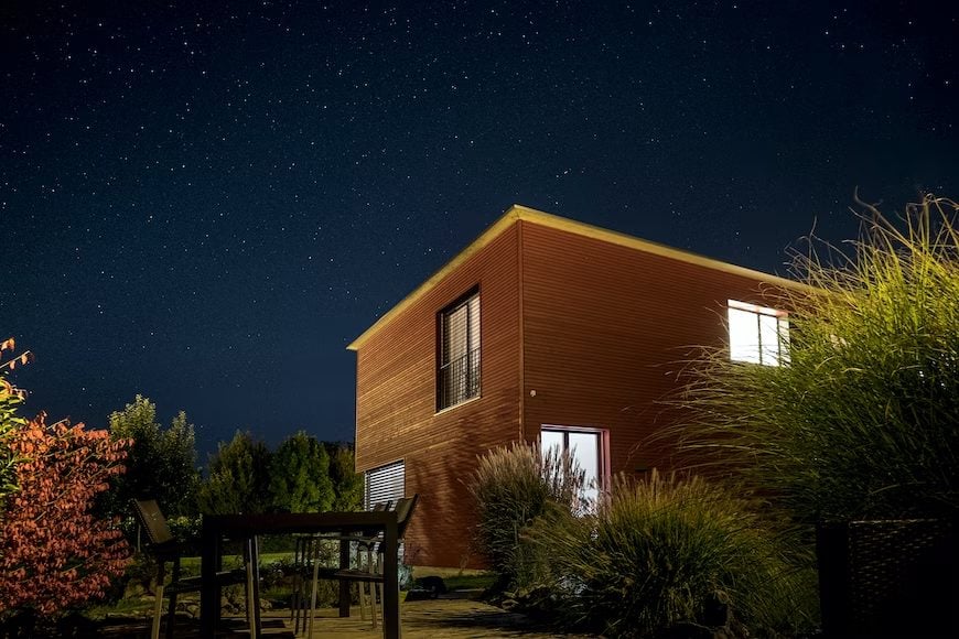 Photo of a house with light open at night 