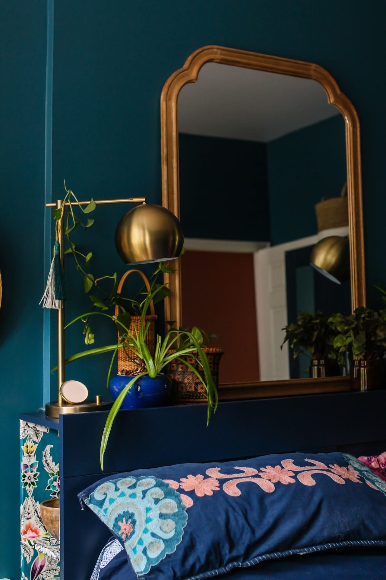 Photo of a mirror in the headboard of a dark colored room