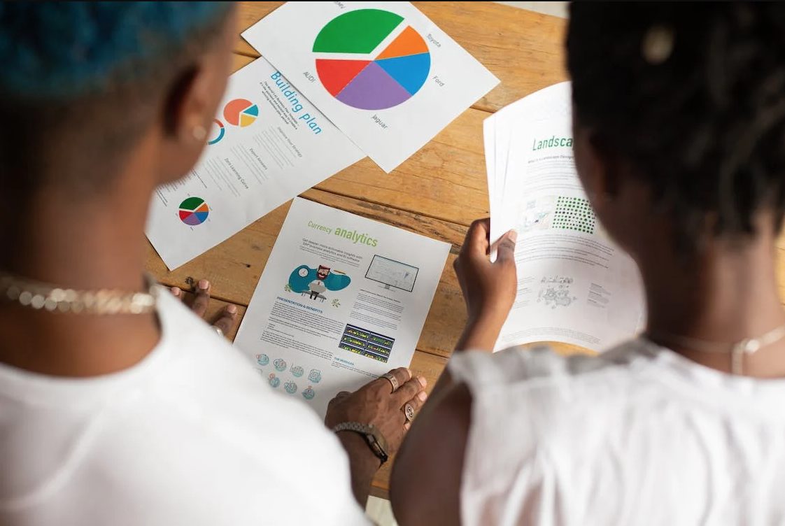 2 people looking at the graphs on the table