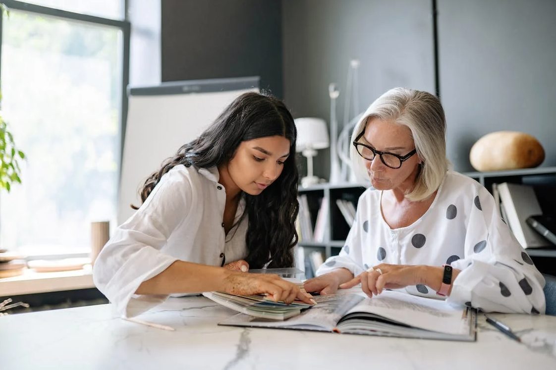 Photo of a young woman having discussion with the older lady