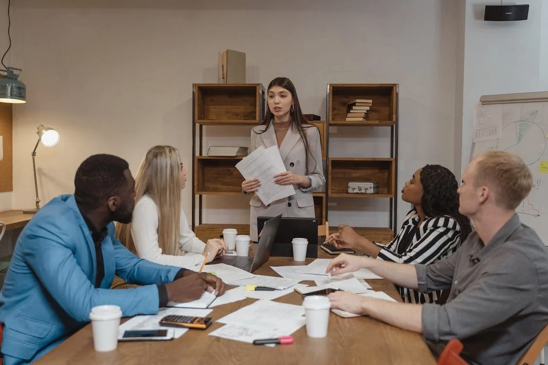 Photo of an office woman discussing work to her colleagues