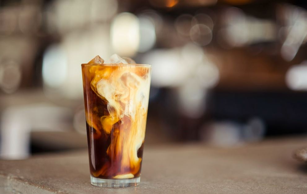 Photo of an iced coffee on a glass placed on a table