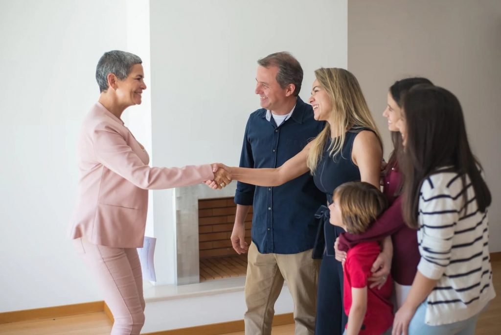 Real estate agent closing a deal with a family