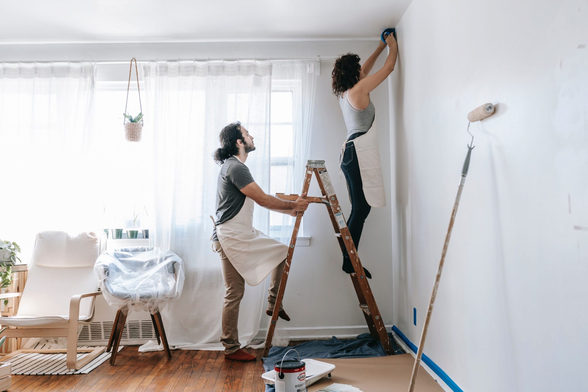 Photo of couple painting a room