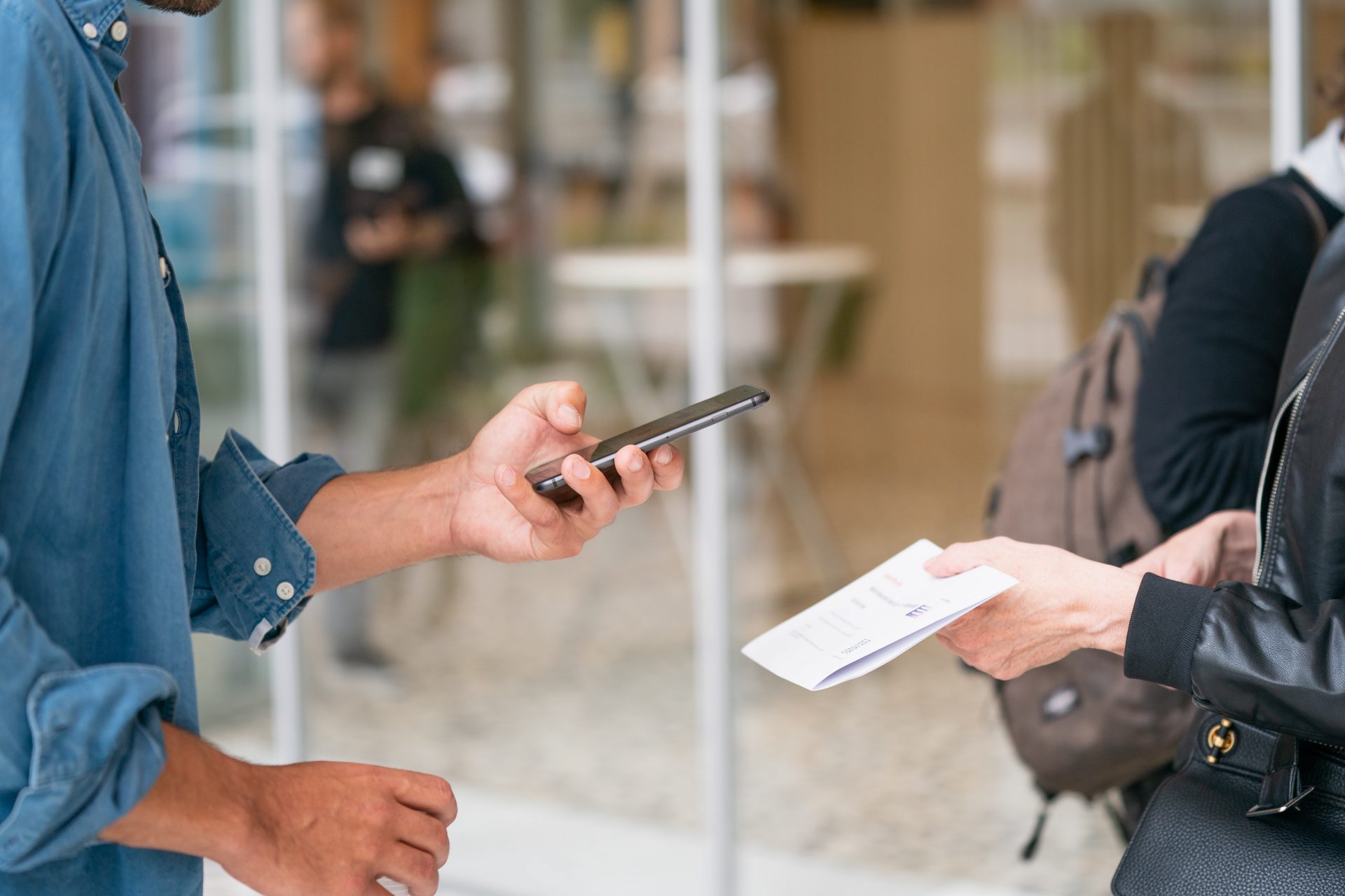 Photo of a guy scanning a QR code using phone