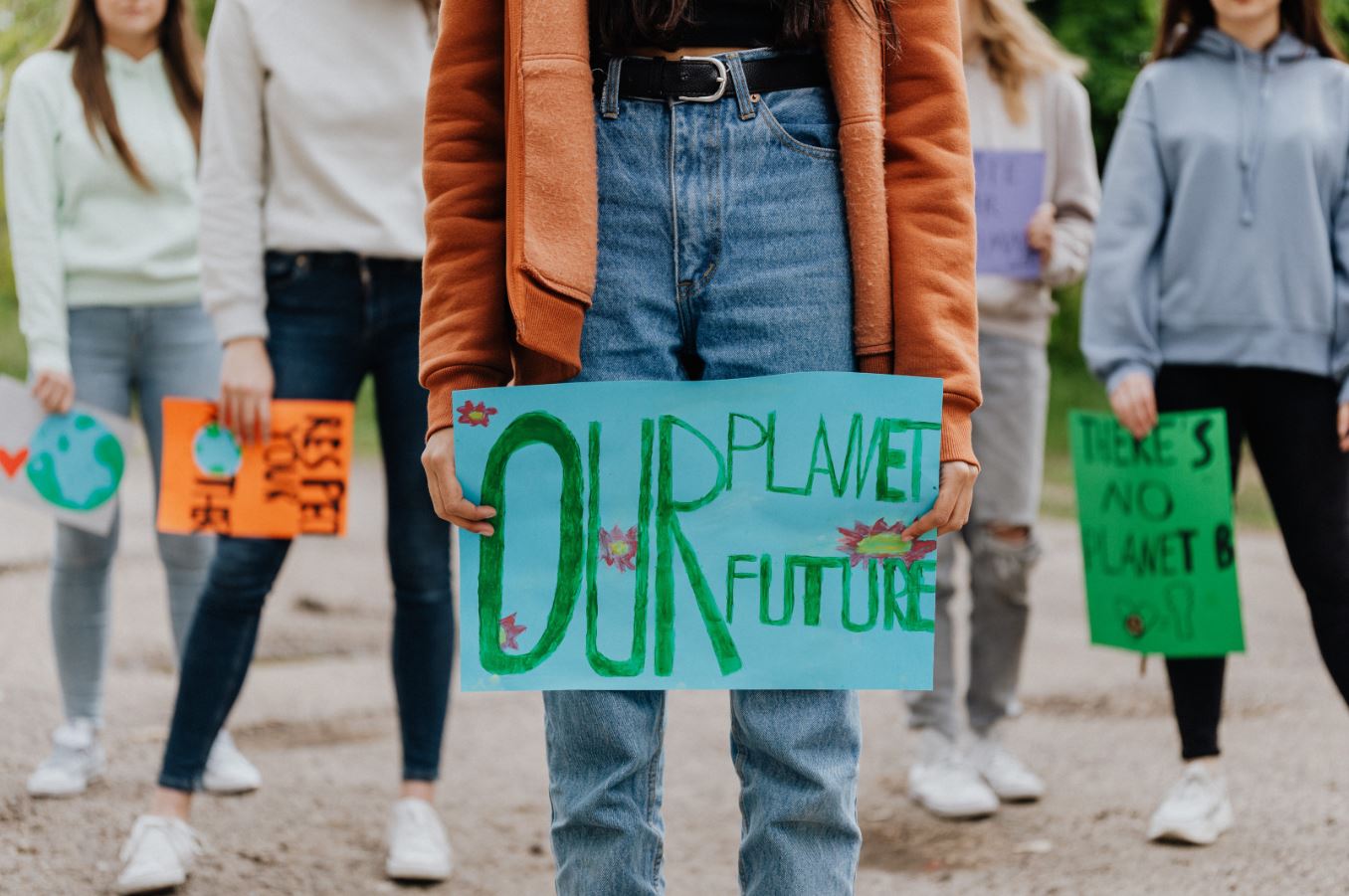 Photo of peaple with signage "Our Planet, our future"