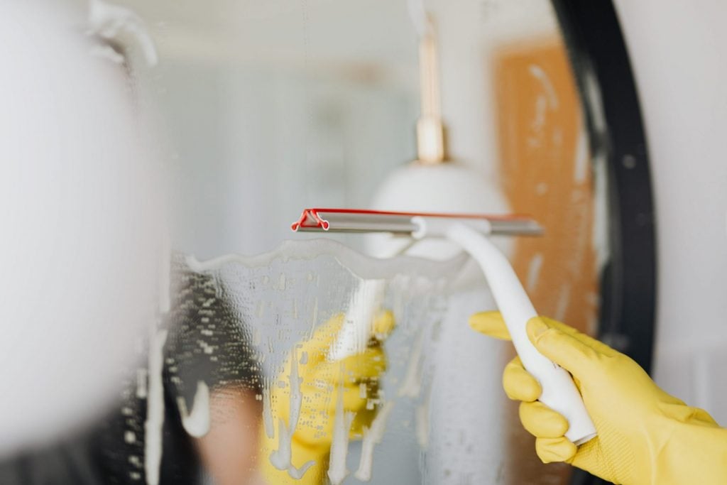 A man cleaning the mirror