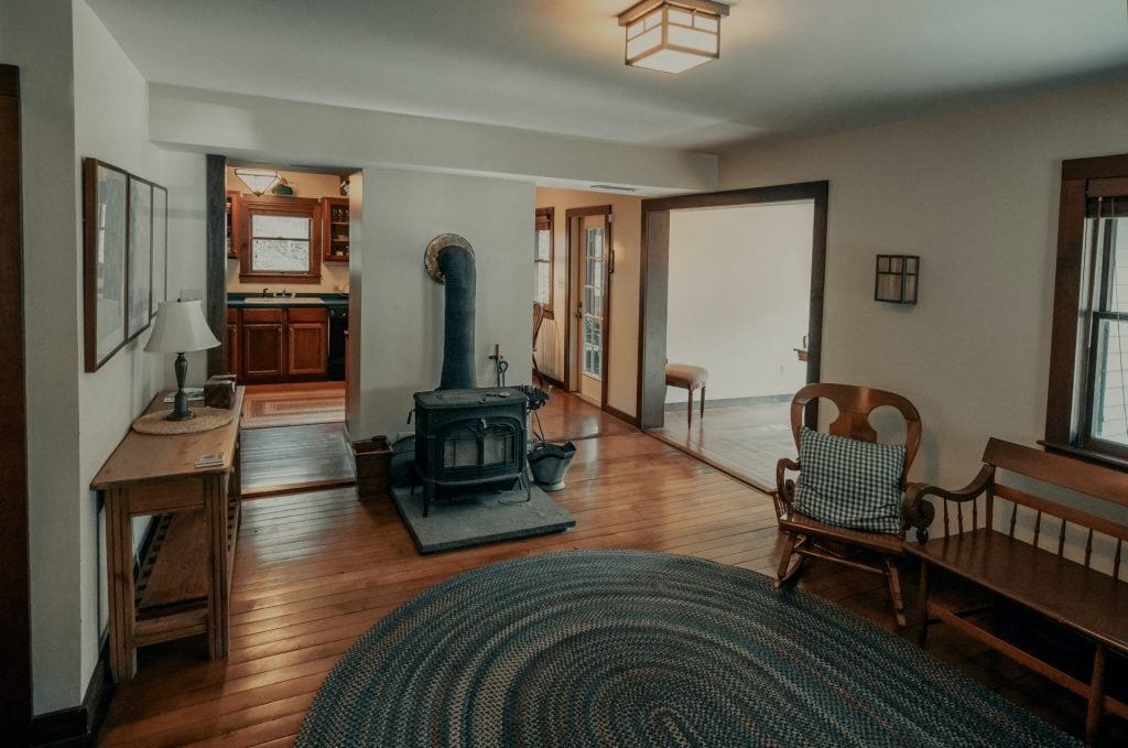 Country home interior design with a wood burning stove in the center.