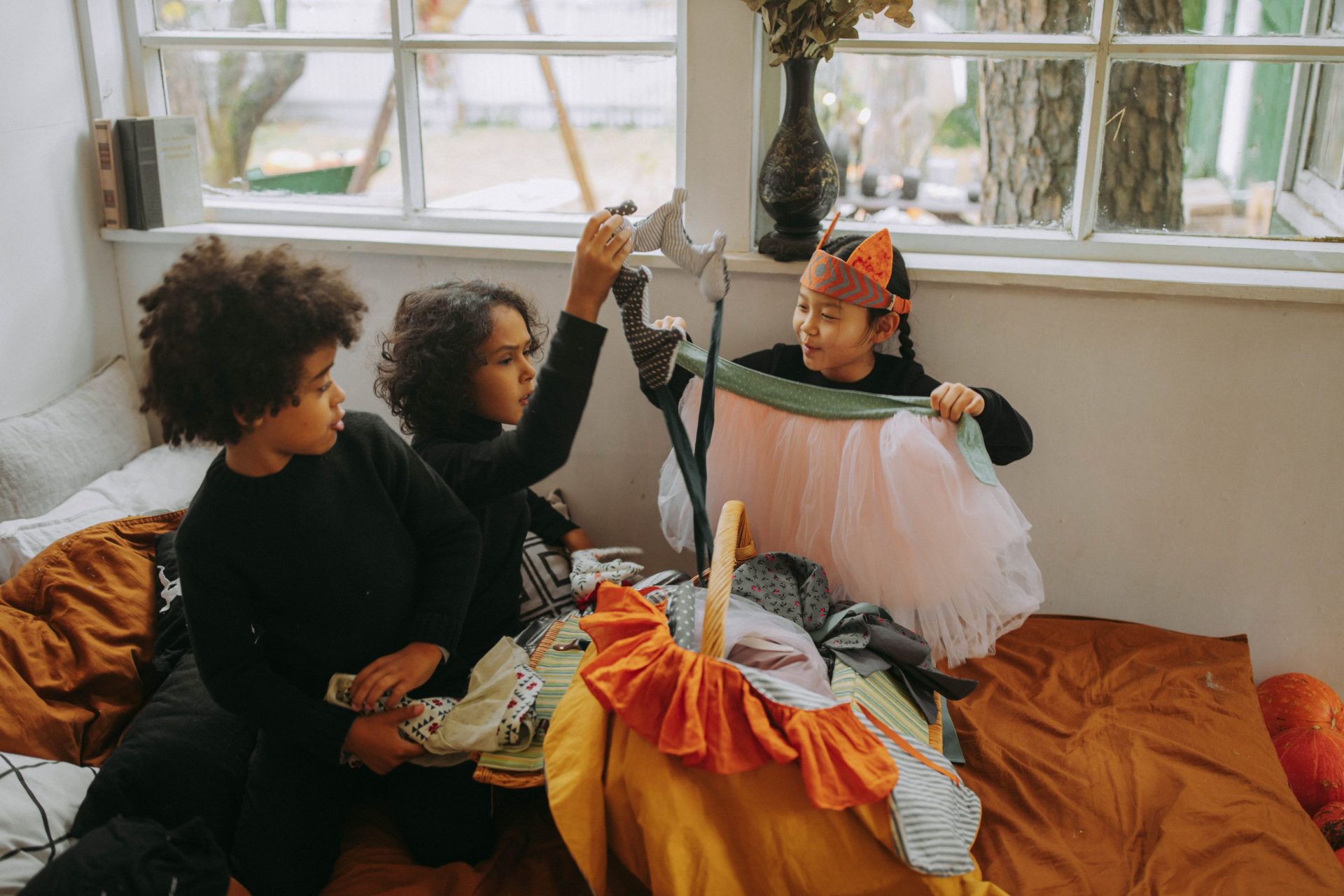 Photo of children playing in the bed while in a halloween costume