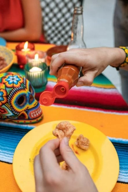 Some people prefer their chicharon with a bit of hot sauce.