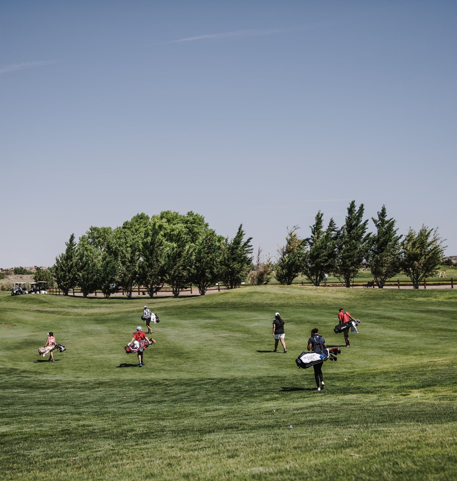 Photo of golf course with players in the field