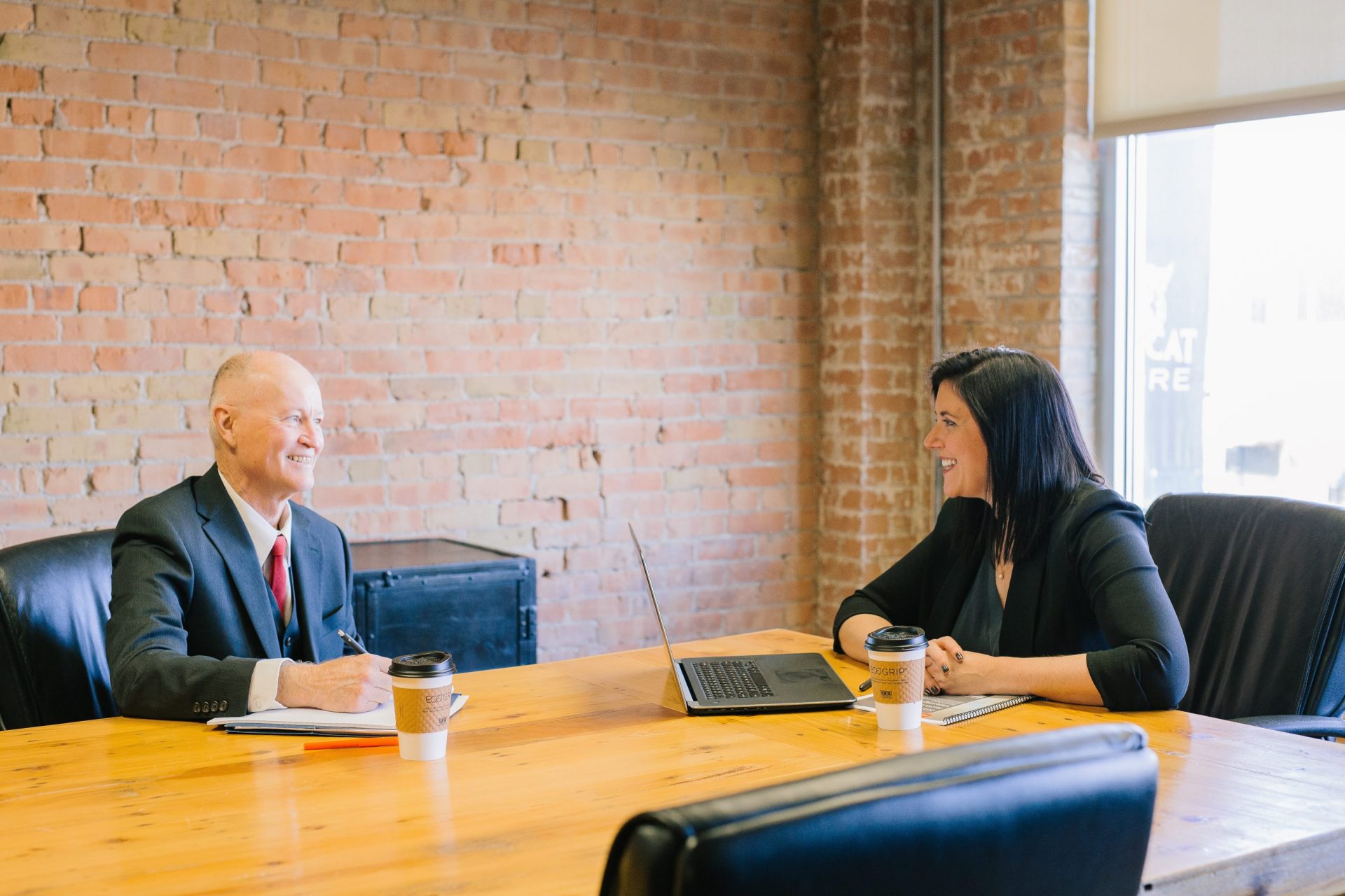 Photo of 2 people having a discussion in a conference room