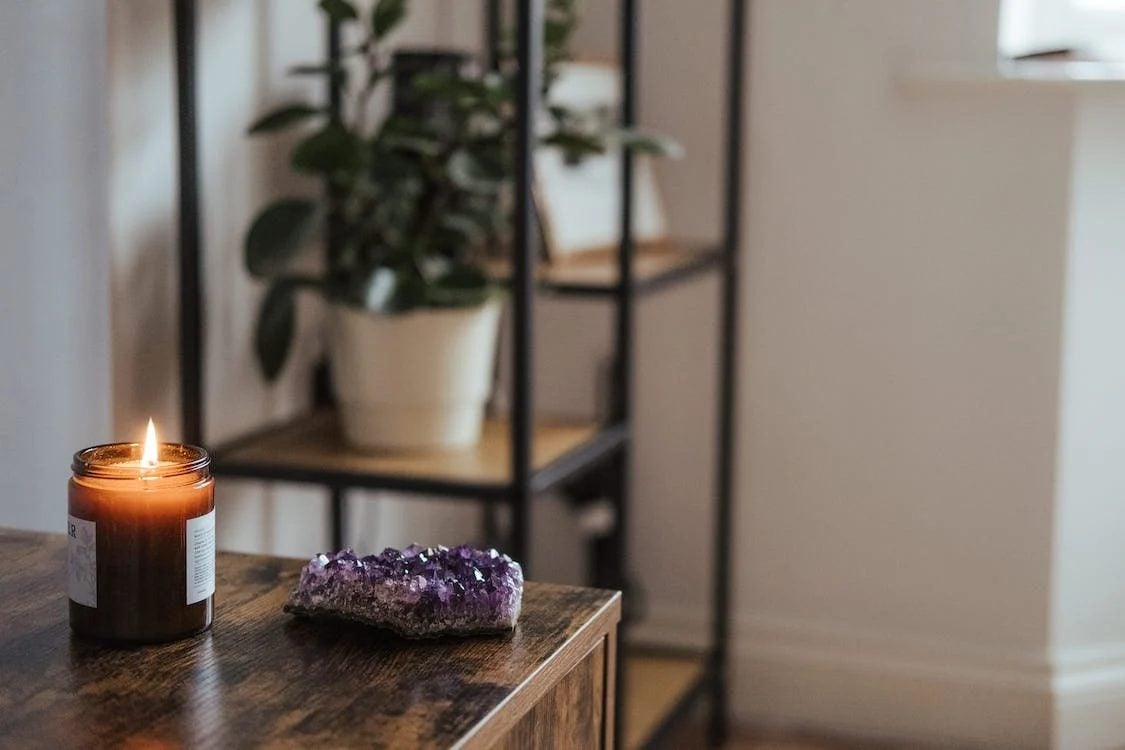 Photo of Gem stones and candles on the table