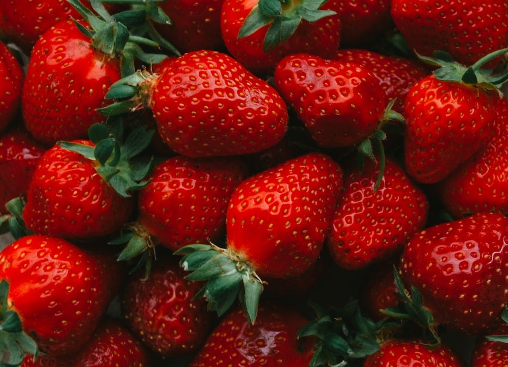 red strawberries on black surface